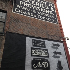 Signage both old and new for the businesses of Blagden Alley.